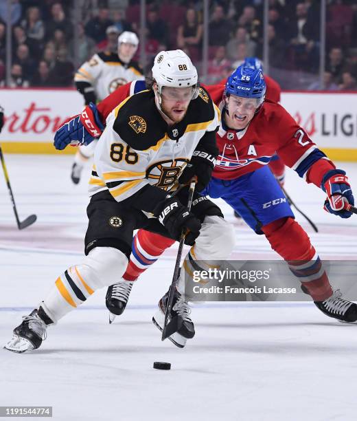 David Pastrnak of the Boston Bruins. Controls the puck against the Montreal Canadiens in the NHL game at the Bell Centre on November 26, 2019 in...