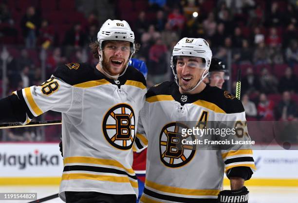 David Pastrnak of the Boston Bruins celebrates with teammates after scoring his second goal of the night against the Montreal Canadiens in the NHL...