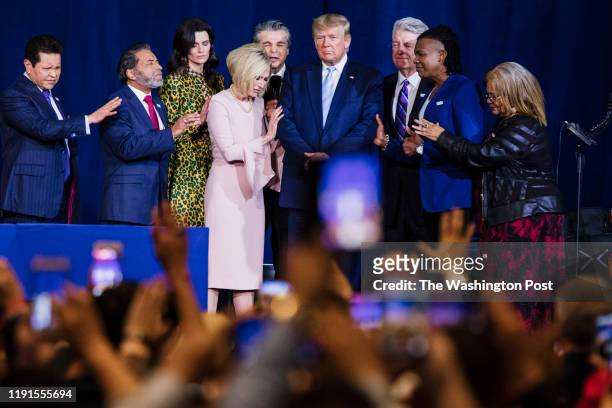 Local religious leaders pray alongside President Donald Trump at the King Jesus International Ministry during a "Evangelicals for Trump" rally in...