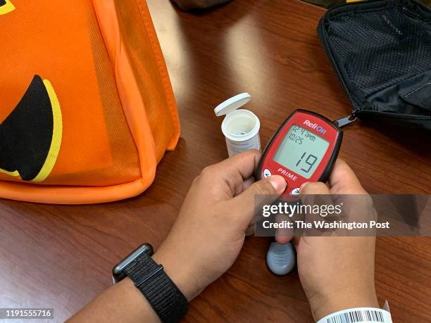 An undocumented immigrant learns how to use a glucometer at Childrens National Hospital in Washington, DC on October 2019. A group of volunteer...