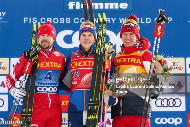 Johannes Hoesflot Klaebo of Norway takes 1st place, Sergey Ustiugov of Russia takes 2nd place, Alexander Bolshunov of Russia takes 3rd place during...