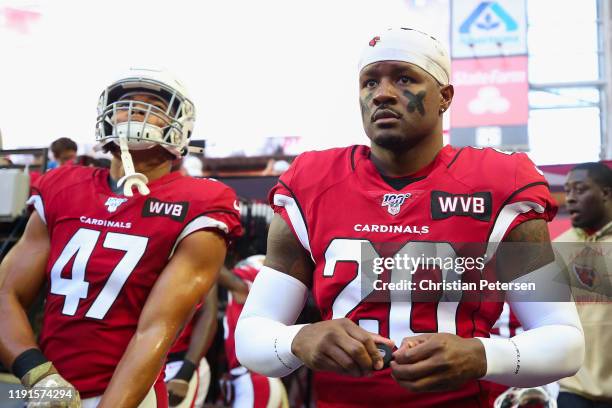 Defensive back Tramaine Brock and linebacker Zeke Turner of the Arizona Cardinals walk onto the field before the NFL game against the Los Angeles...