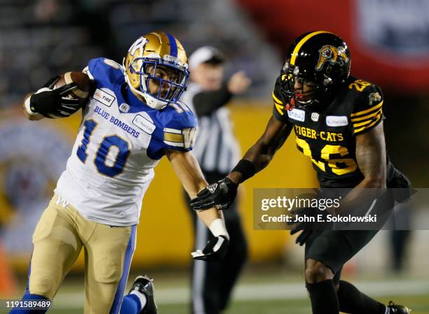 Nic Demski of the Winnipeg Blue Bombers tries to get around Cariel Brooks at McMahon Stadium on November 24, 2019 in Calgary, Canada. Winnipeg Blue...