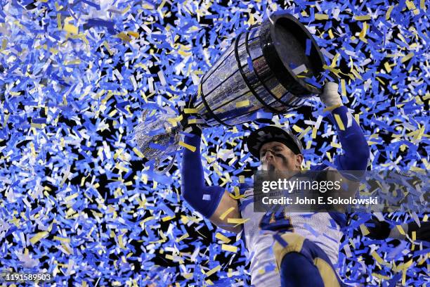 Adam Bighill of the Winnipeg Blue Bomberscelebrates with the Grey Cup after a win over the Hamilton Tiger-Cats at McMahon Stadium on November 24,...