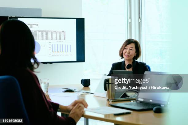 female business owner talking during meeting in office conference room - president trump meets with members of the senate finance committee at the white house stockfoto's en -beelden