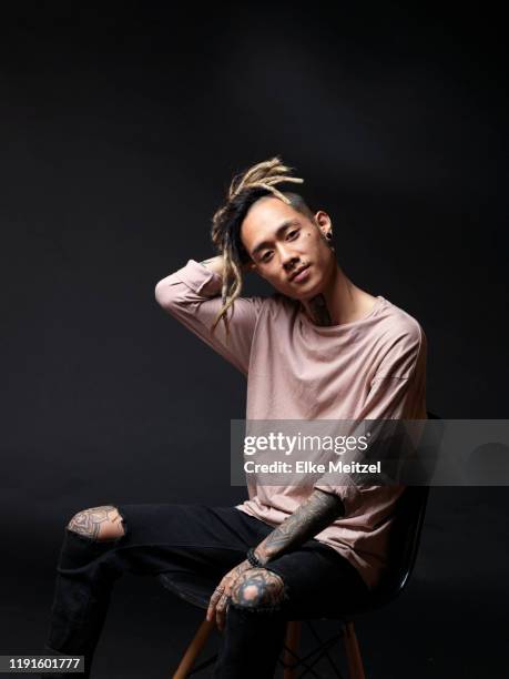 young man with tattoos sitting on chair - modern manhood stock pictures, royalty-free photos & images