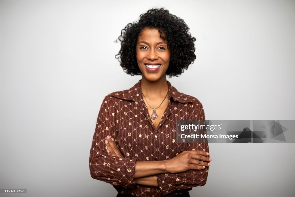 Confident businesswoman against white background