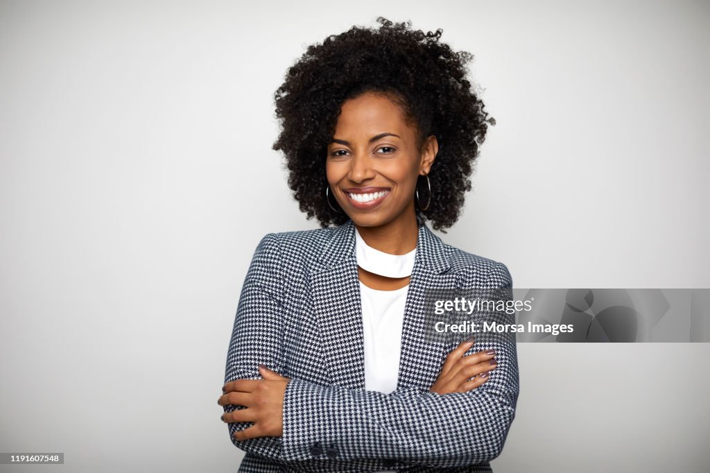 Smiling businesswoman against white background