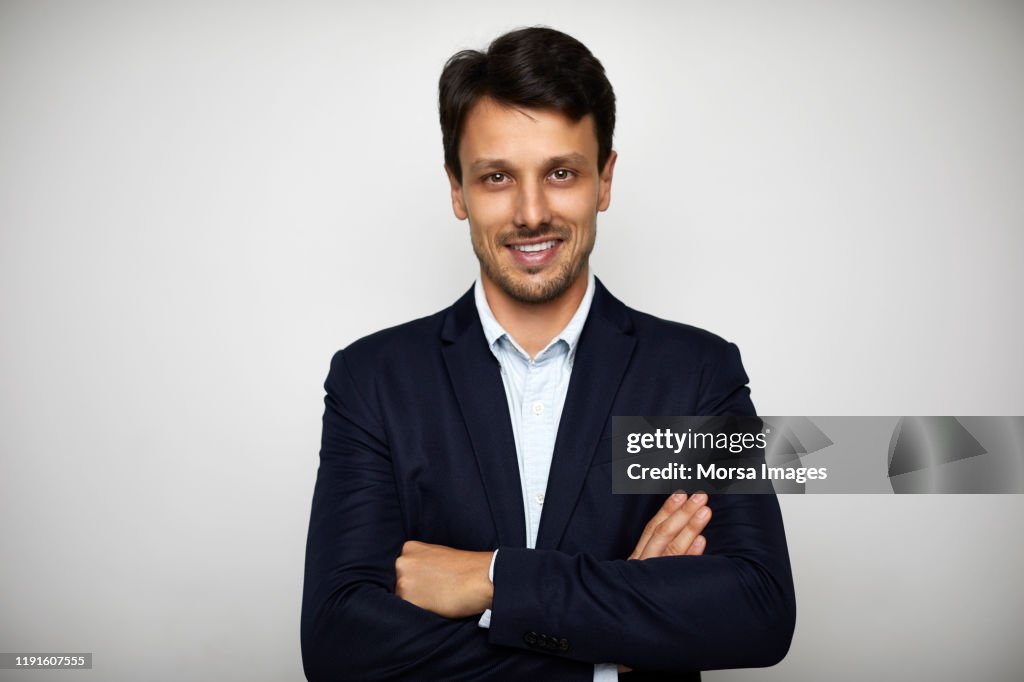 Confident businessman standing with arms crossed