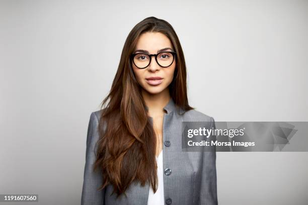 young businesswoman against white background - lady 30s wearing glasses stock pictures, royalty-free photos & images