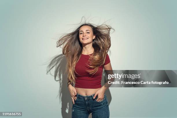 portrait of a young woman - hair blowing stockfoto's en -beelden