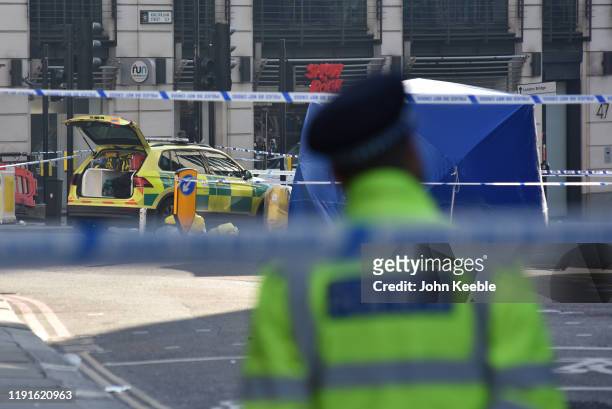 Police officer stands at the scene of yesterday's London Bridge stabbing attack on November 30, 2019 in London, England. A man and a woman were...