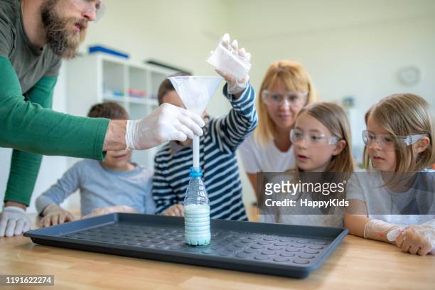 students doing foam fountain experiment - medium group of people stock pictures, royalty-free photos & images
