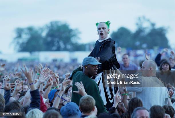 English singer and musician Keith Flint of The Prodigy leaves the stage to crowd surf over the audience during the group's support slot for rock...