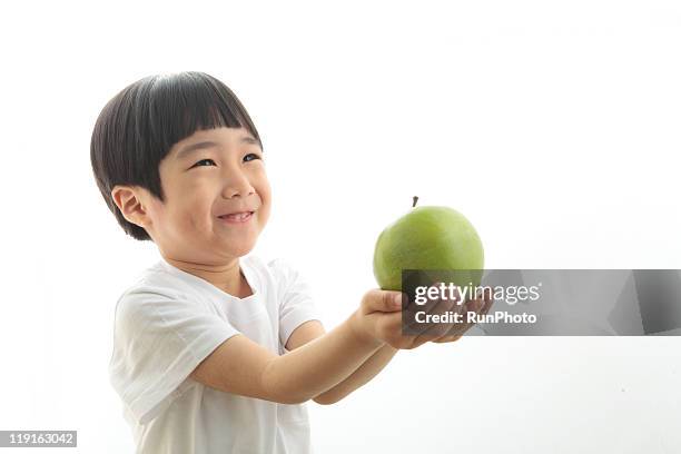 little boy  playing - child holding apples stock-fotos und bilder