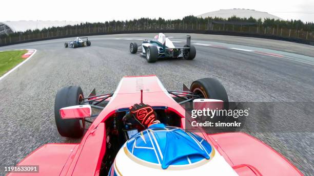 racing cars driving on track - will power race car driver stock pictures, royalty-free photos & images