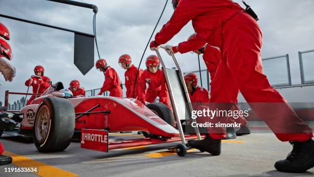 pit crew working at pit stop - pit stop stock pictures, royalty-free photos & images