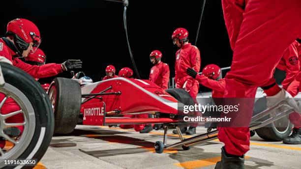 pit crew working at pit stop - pit crew challenge stock pictures, royalty-free photos & images