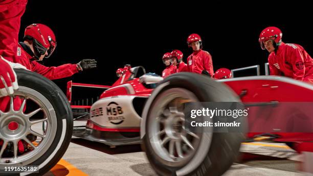 pit crew working at pit stop - pit stop stock pictures, royalty-free photos & images