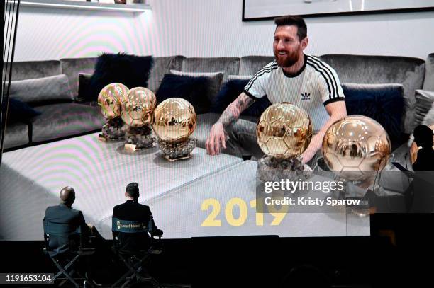 Lionel Messi watches a congratulatory video with host Didier Drogba after winning his sixth Ballon D'Or award during the Ballon D'Or Ceremony at...