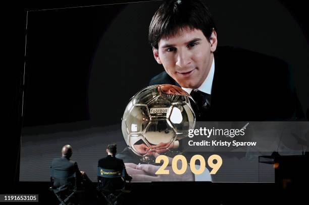 Lionel Messi watches a congratulatory video with host Didier Drogba after winning his sixth Ballon D'Or award during the Ballon D'Or Ceremony at...