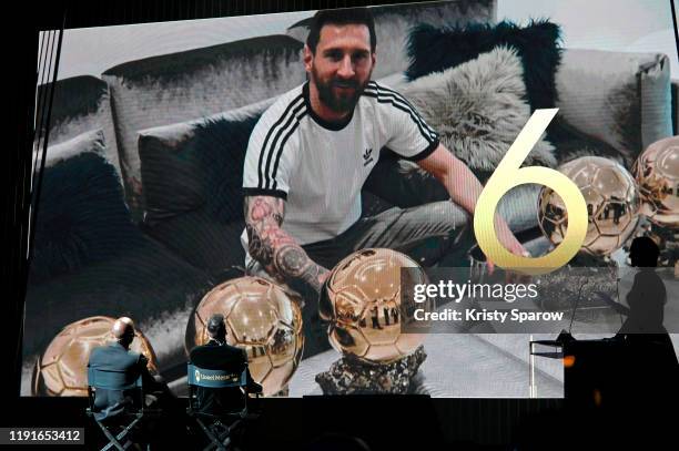 Lionel Messi watches a congratulatory video with hosts Didier Drogba and Sandy Heribert after winning his sixth Ballon D'Or award during the Ballon...