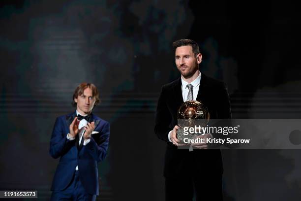 Lionel Messi excepts his sixth Ballon D'Or award from Luka Modric during the Ballon D'Or Ceremony at Theatre Du Chatelet on December 02, 2019 in...