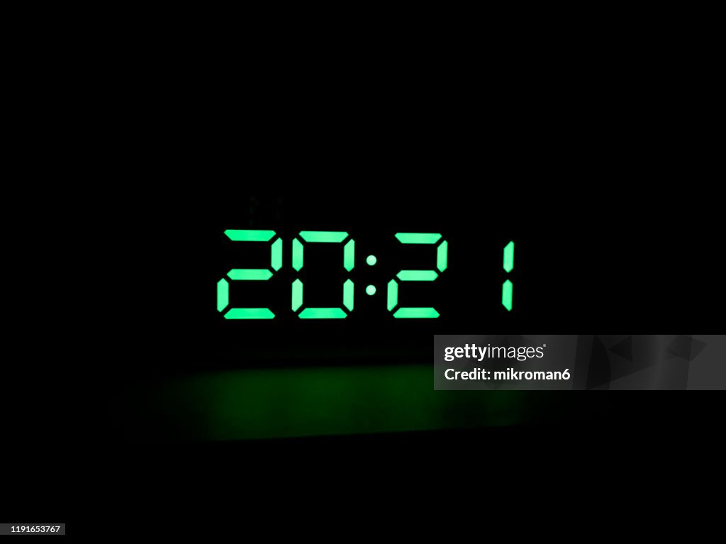 Real green led digital clock showing time 20:21