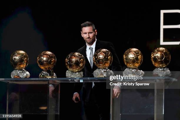 Lionel Messi poses onstage after winning his sixth Ballon D'Or award during the Ballon D'Or Ceremony at Theatre Du Chatelet on December 02, 2019 in...