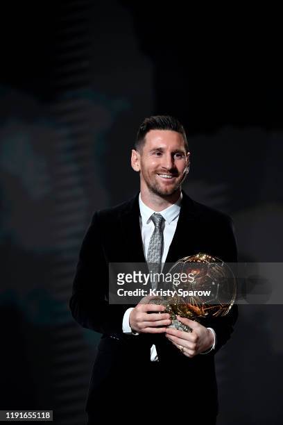 Lionel Messi poses onstage after winning his sixth Ballon D'Or award during the Ballon D'Or Ceremony at Theatre Du Chatelet on December 02, 2019 in...