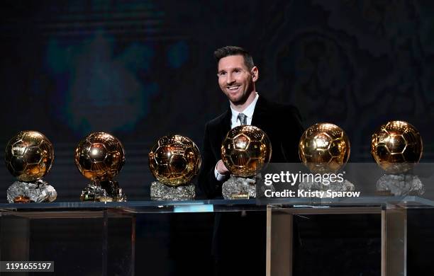 Lionel Messi poses onstage after winning his sixth Ballon D'Or award during the Ballon D'Or Ceremony at Theatre Du Chatelet on December 02, 2019 in...