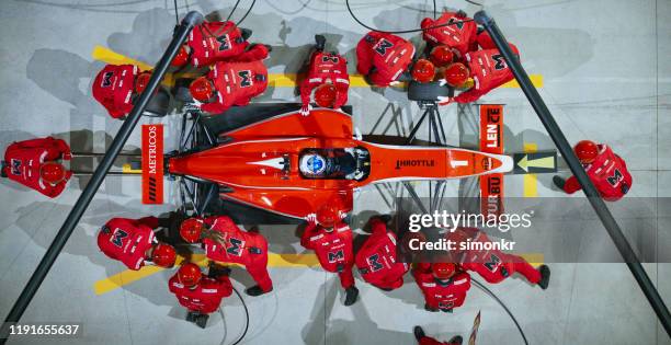 pit crew working at pit stop - pit stop top view stock pictures, royalty-free photos & images