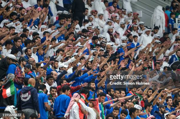 Kuwait supporters chant for their team during the Gulf Cup group stage match between Kuwait and Bahrain at the Khalifa International Stadium on...
