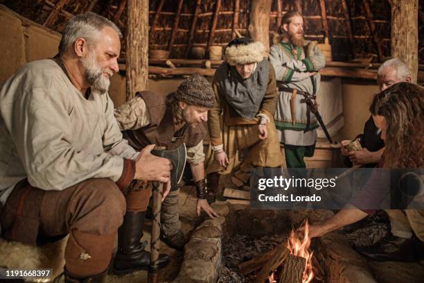 a group of viking male villagers in a hall - danish culture stock pictures, royalty-free photos & images