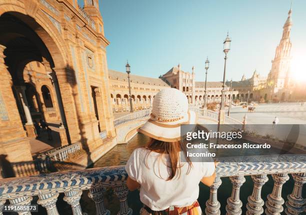 woman admiring plaza de espana, seville, andalucia, spain - seville stockfoto's en -beelden