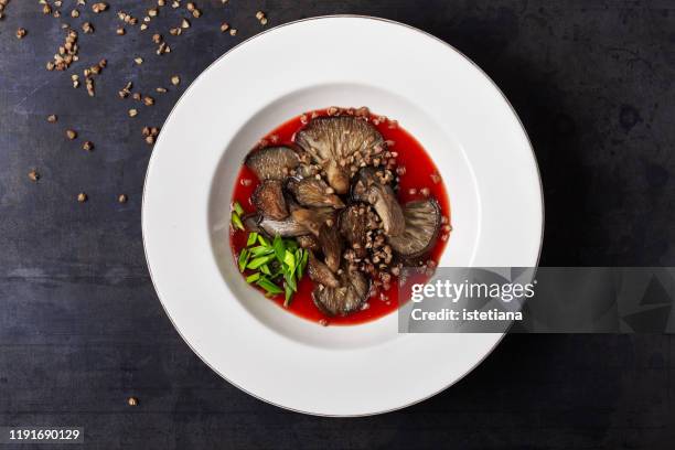 oyster mushrooms in pepper tomato sauce and buckwheat - schwindling stock-fotos und bilder