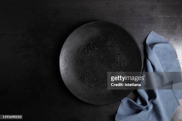 empty rustic black concrete plate and linen napkin - black plate stock pictures, royalty-free photos & images