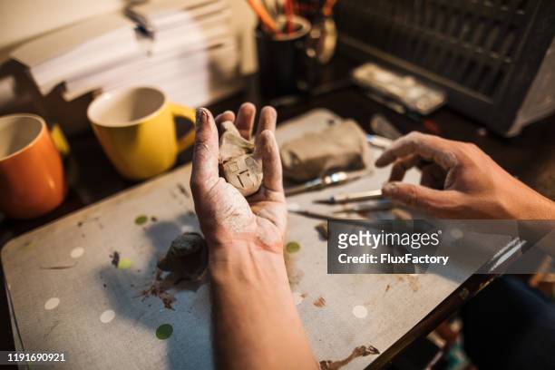 man making a clay house in his workshop - sweet little models stock pictures, royalty-free photos & images