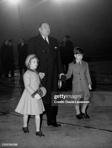 Prince Charles And Princess Anne wait to greet their parents, Queen Elizabeth II and Prince Philip, who had just returned to London Airport, from a...