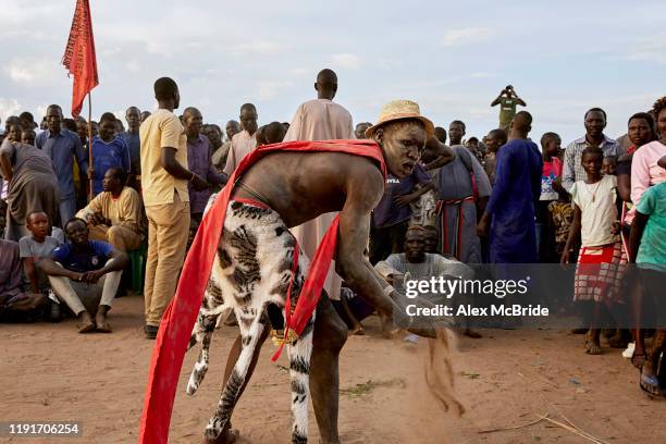 Wrestler dusts his hands before sparring in a wrestling competitionon December 1, 2019 in Shirkat, South Sudan. Two teams of wrestlers, one...