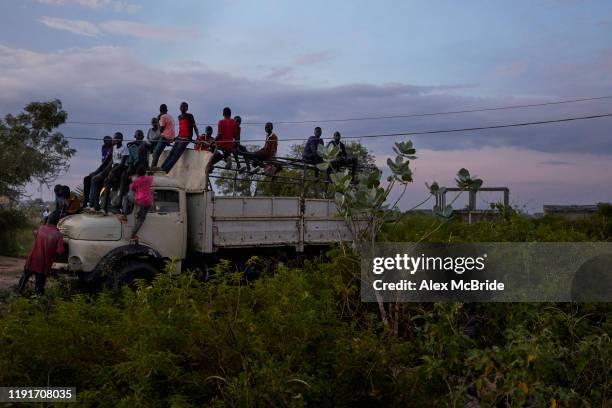 Boys watch sit together after a wrestling competitionon December 1, 2019 in Shirkat, South Sudan. Two teams of wrestlers, one representing Jonglei...