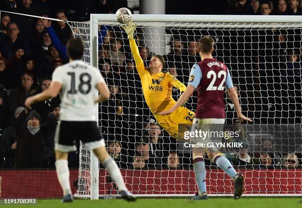 Fulham's Irish midfielder Harry Arter watches as his shot beats the dive of Aston Villa's Norwegian goalkeeper Orjan Nyland for their second goal...