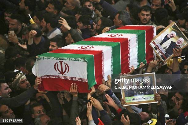 Mourners carry the coffins of slain Iraqi paramilitary chief Abu Mahdi al-Muhandis, Iranian military commander Qasem Soleimani and eight others...