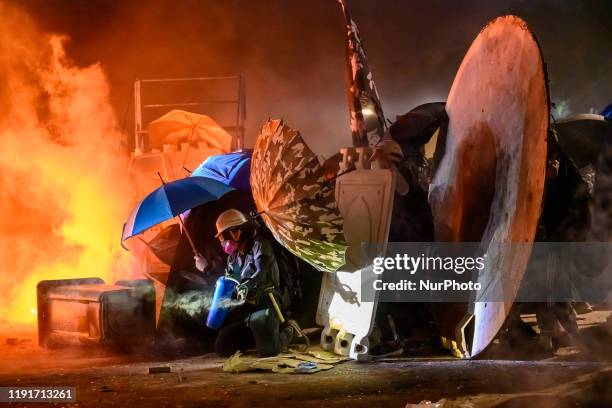 Protestors using improvise shield to push toward Police checkline on Nov 12, 2019. Battle of Number two bridge in the Chinese University of Hong...