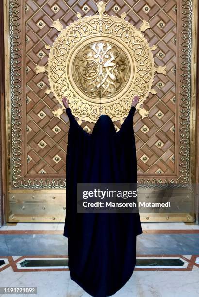 a woman infront of the king abdul azeez gate of prophet's mosque, medina - muhammad prophet stock pictures, royalty-free photos & images
