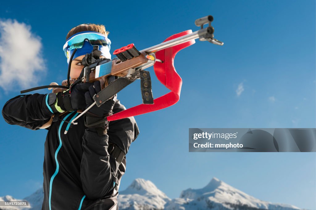 Shot of Young Female Biathlon Competitor Target Shooting