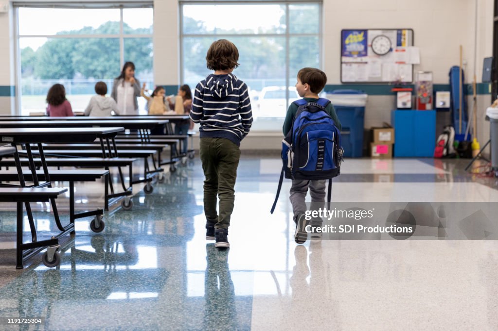 Rear view of schoolboys in cafeteria