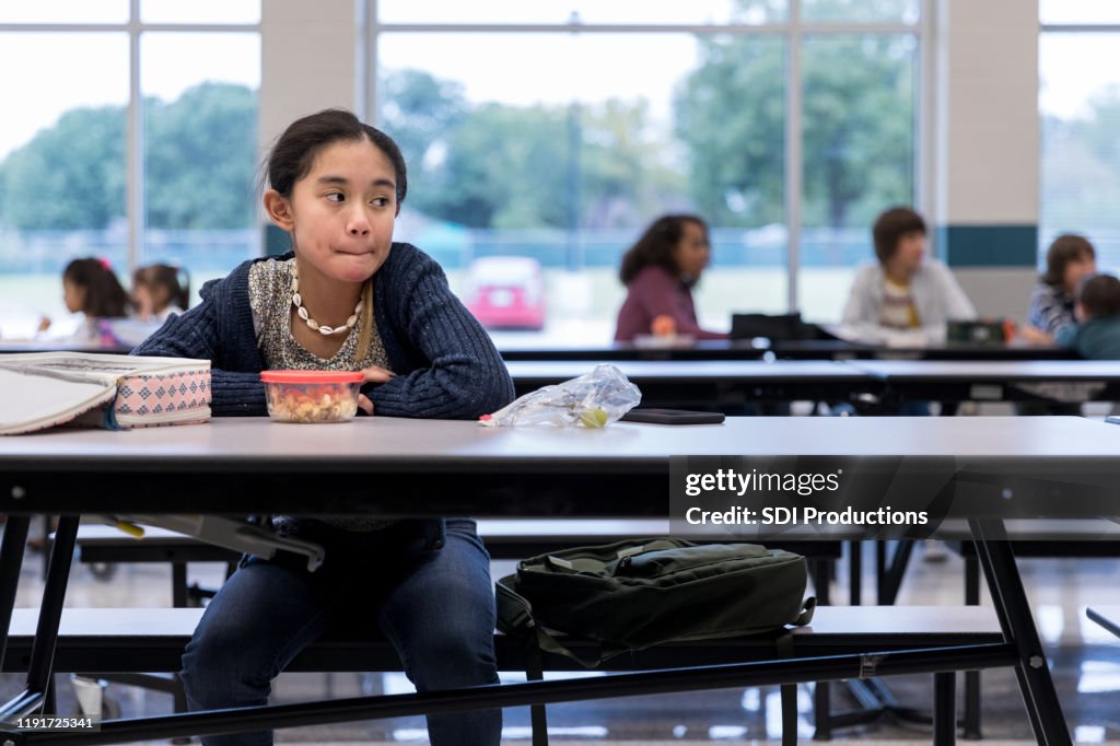 Lonely middle school student in cafeteria