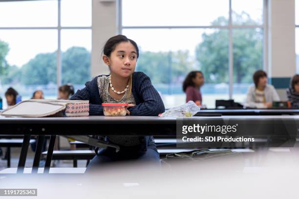 upset schoolgirl eating alone - exclusion stock pictures, royalty-free photos & images