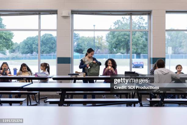 group of schoolchildren eating lunch - school lunch stock pictures, royalty-free photos & images